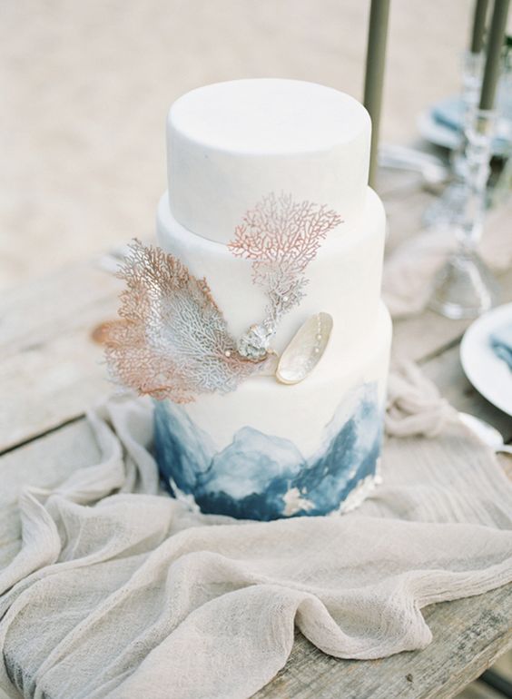 a white and navy watercolor cake with corals, pearls and seashells is a lovely idea for a mermaid bridal shower