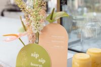 colorful bridal shower signage in peachy pink and green, with matching blooms are great for a retro bridal shower