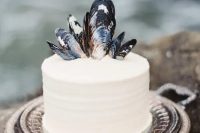 offer your friends a white buttercream wedding cake topped with oyster shells to give it a coastal feel