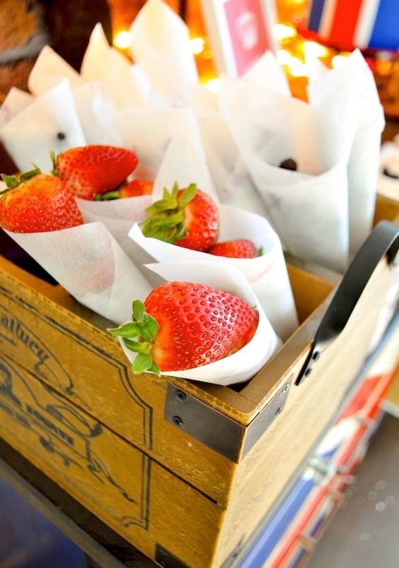 paper cones with fresh strawberries is a cool dessert or favor idea for a cowgirl bridal  shower