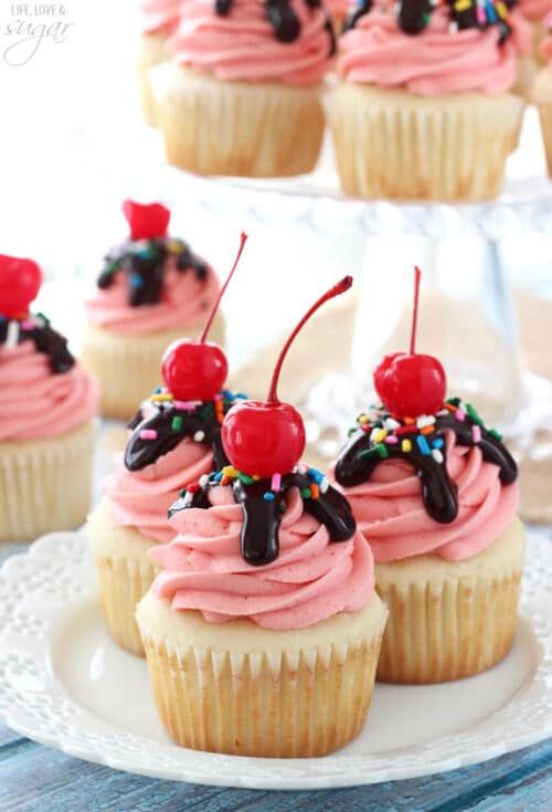 strawberry sundae cupcakes with chocolate, sprinkles and cherries on top are amazing to serve at a retro bridal shower