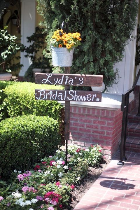style your sign with a bucket with bright blooms over it to embrace the style of your shower
