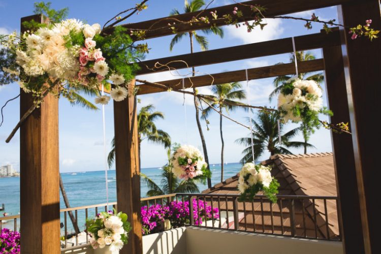 the wedding arch was simple but decorated with floral bombs