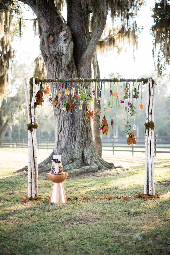 boho fall arch with hanging flowers and leaves