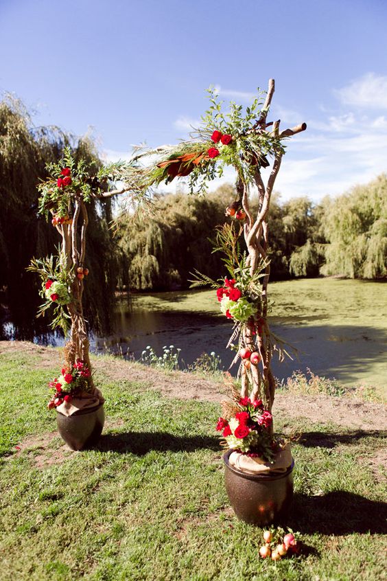rustic living arch with bold red flowers