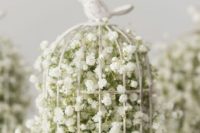 Birdcage filled with baby breath flowers