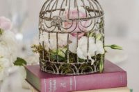 Birdcage table centerpiece with books