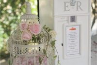 Birdcage wedding decor with roses