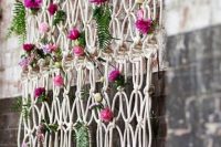 Macrame knotted wedding backdrop with flowers