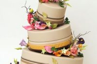 Topsy turvy wedding cake with flowers between tiers