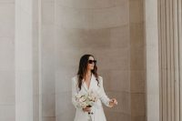 a classy white pantsuit with flare pants and white shoes is great for any wedding-related party or a wedding