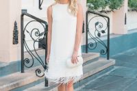 a knee white dress with beading and feathers, flats with fluffs and an embellished clutch are a cool look for a bridal shower