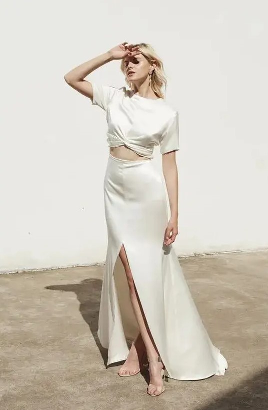 a minimalist plain separate with a silk crop top with short sleeves and an A-line maxi skirt with a front slit