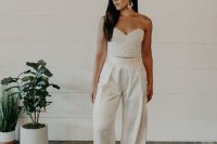 an embellished corset bodice plua high waisted wideleg pants and statement earrings are a lovely combo for a bridal shower
