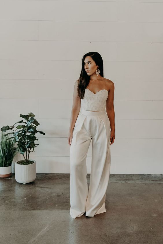 an embellished corset bodice plua high waisted wideleg pants and statement earrings are a lovely combo for a bridal shower