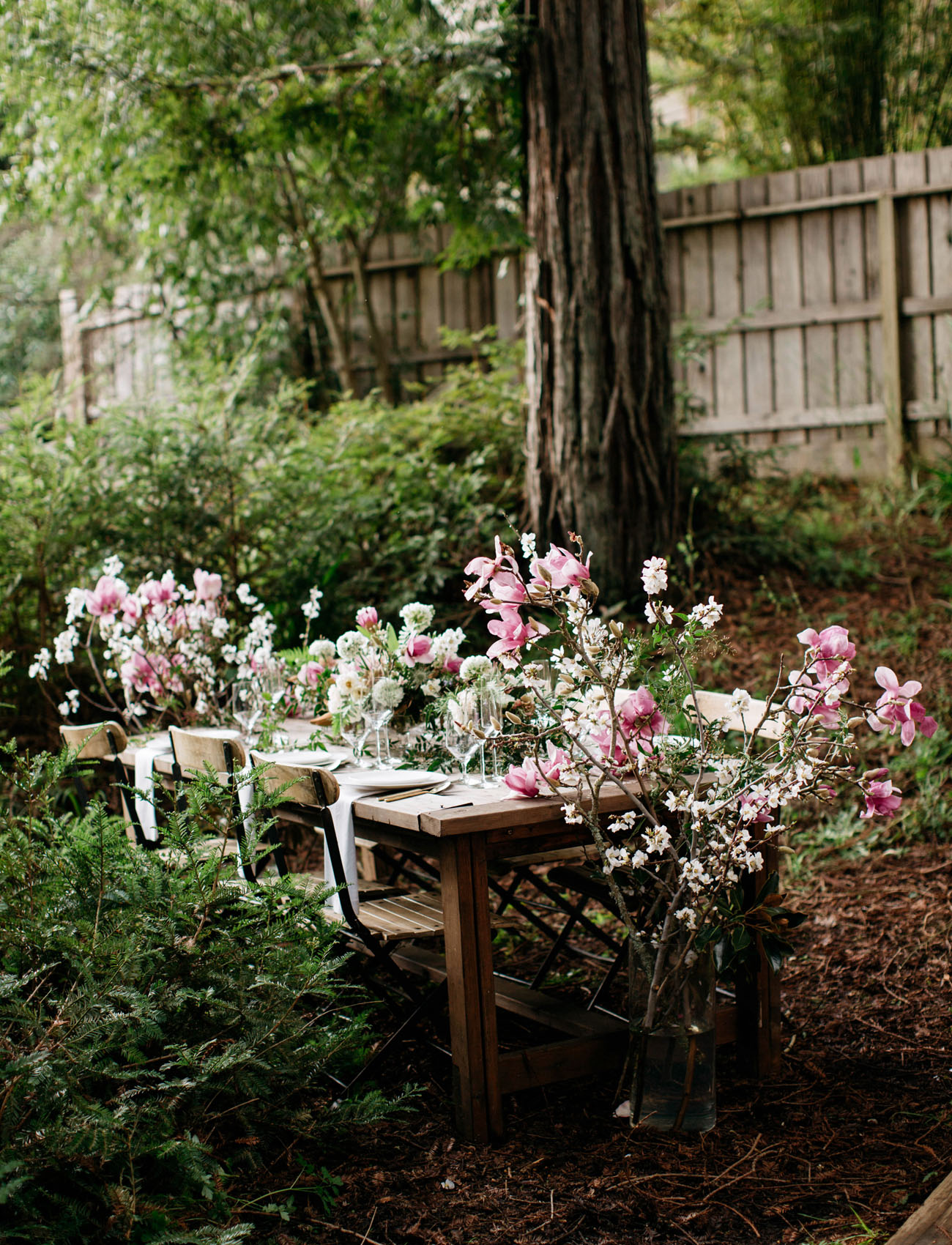 Rustic woodland wedding table setting with pink florals