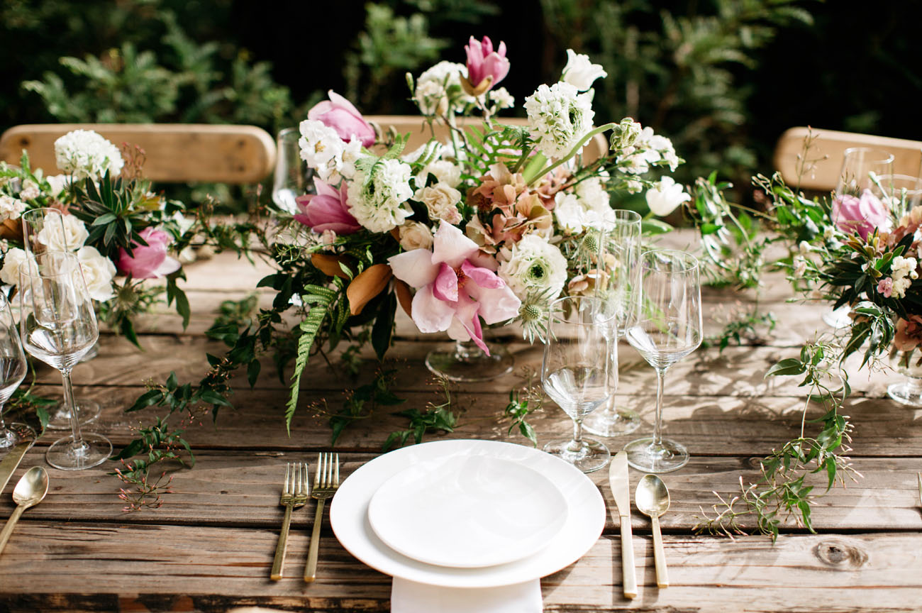 Pink flower centerpieces look beautiful and unexpected for a woodland wedding