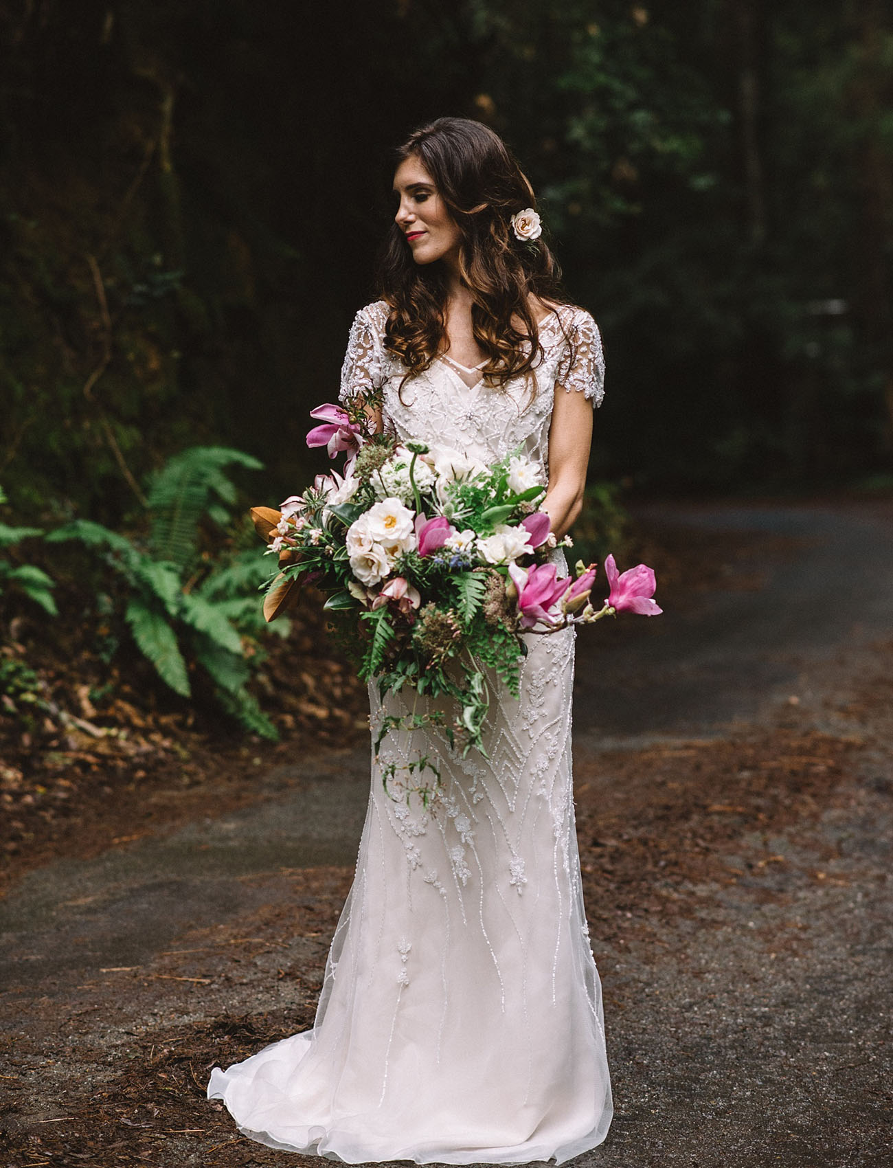 The bride is rocking a gorgeous BHLDN wedding dress, with intricate silver embroidery