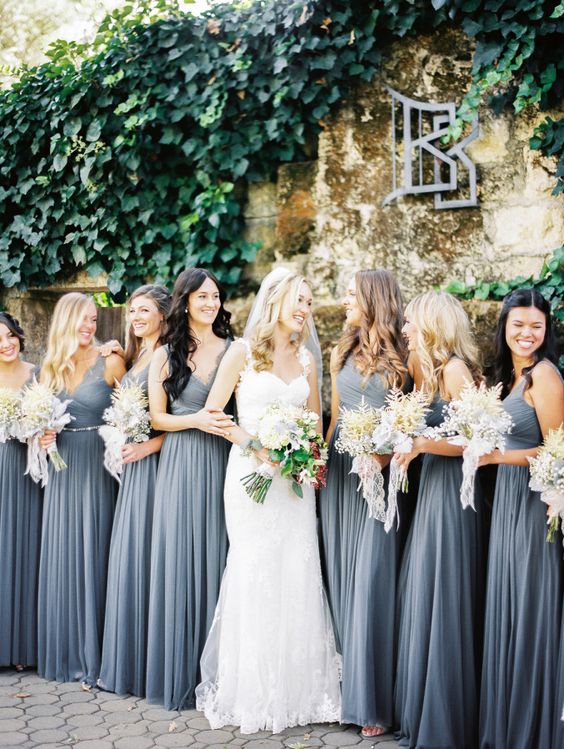 grey maxi bridesmaids' gowns is a great contrast with a bride's dress