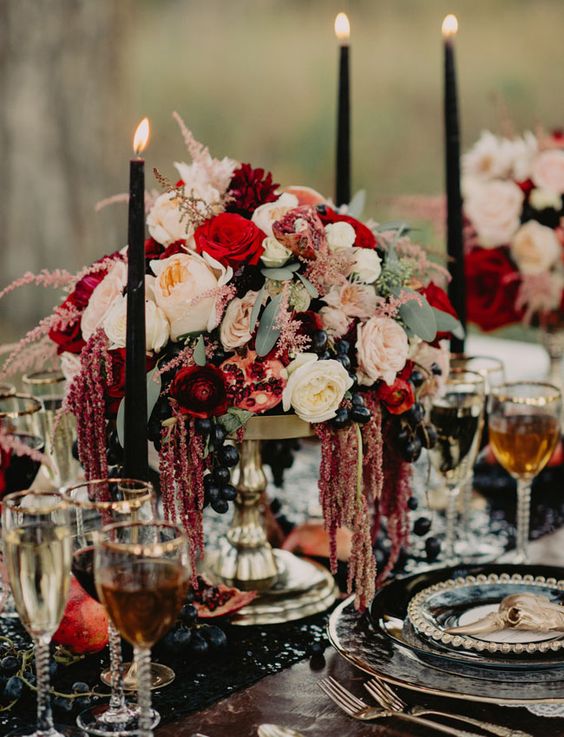 27 decadent tablescape with a burgundy centerpiece with pomegranates and dripping amaranthus