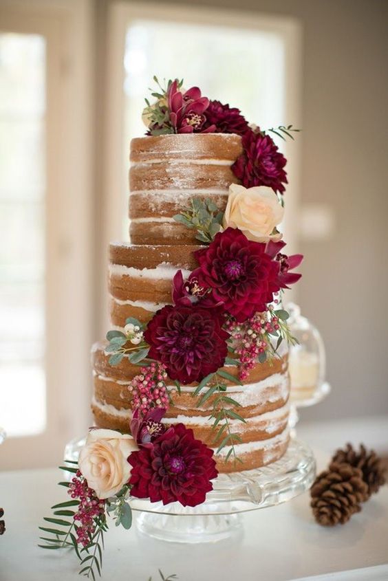  naked fall wedding cake decorated with burgundy dahlias