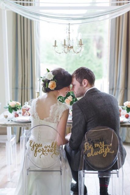 Bride's and groom's chairs with sweet words on them