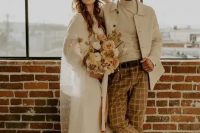 a creamy turtleneck, a creamy jacket, rust-colored windowpane pants, tan Chelsea boots are a great look for a boho wedding