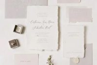 a delicate and ethereal light grey and white wedding invitation suite with a raw edge and calligraphy is a fantastic idea for a minimalist wedding
