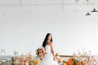 a gorgeous fall wedding altar composed of pumpkins, moss, blooms and foliage looks amazing and embraces the season