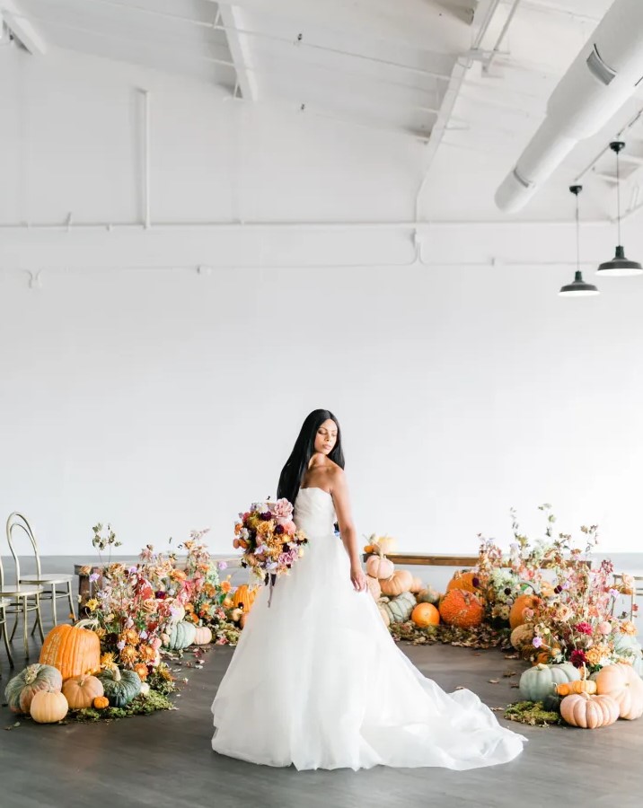 a gorgeous fall wedding altar composed of pumpkins, moss, blooms and foliage looks amazing and embraces the season