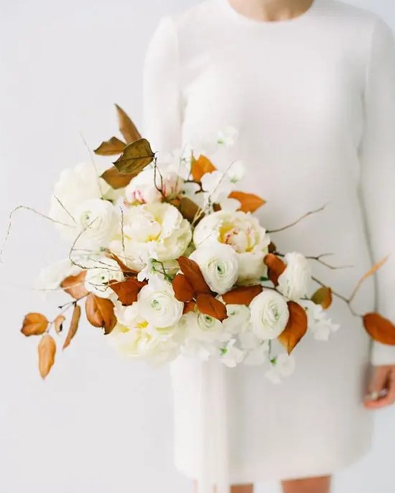 a neutral bridal bouquet with some twigs and rust-colored leaves for a contrast