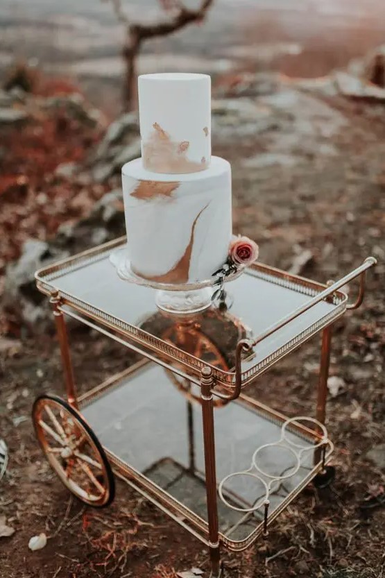 a refined modern fall wedding cake with rust and dusty pink brushstrokes and a single pink rose is a very cool idea for the fall