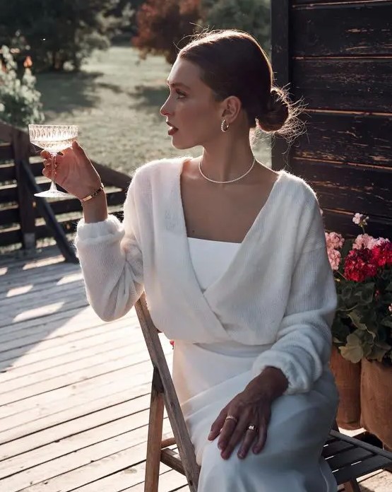 a slip white dress paired with a semi-sheer white cropped cardigan, some chic jewelry are great for a bride-to-be