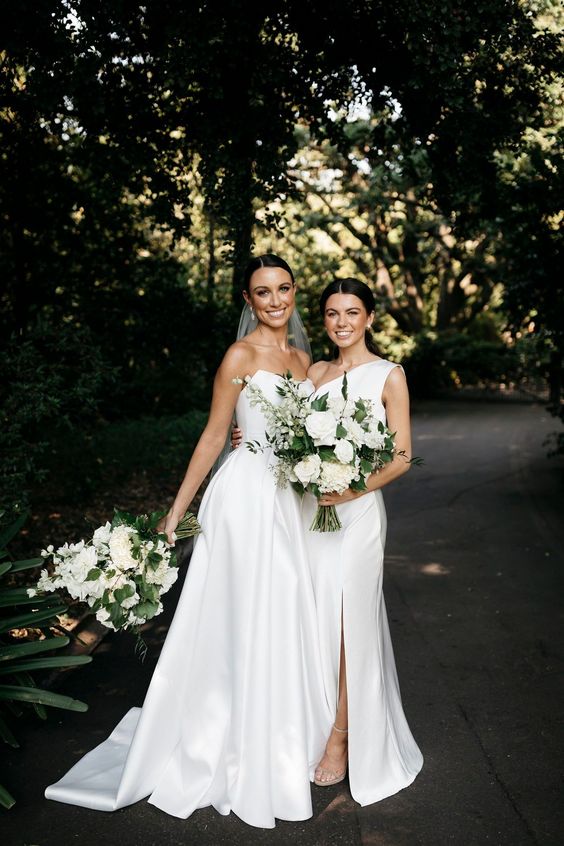 a white one shoulder maxi bridesmaid dress with a slit is a lovely idea for a modern and chic summer wedding