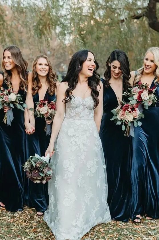 beautiful and chic navy velvet maxi bridesmaid dresses with A-line skirts and deep necklines look very elegant