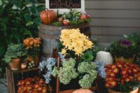 beautiful fall wedding decor with lots of pumpkins and blooms and greenery, a chalkboard and some veggies is a lovely idea