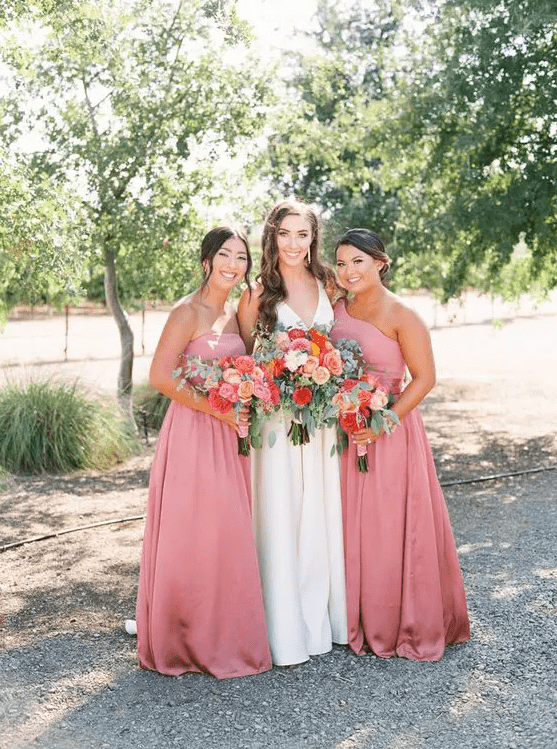 beautiful strapless and one shoulder pink maxi bridesmaid dresses with pleated skirts are amazing for summer weddings
