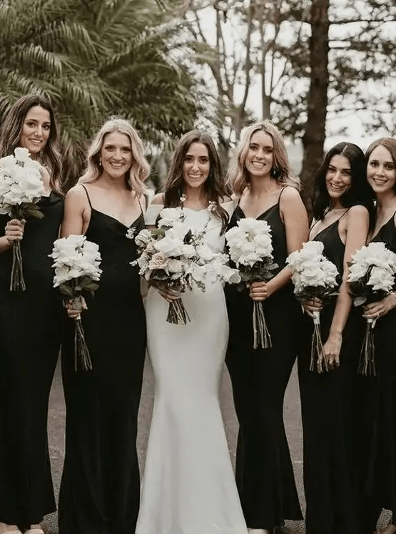 Black slip maxi bridesmaid dresses with V necklines are amazing for a bold fall or winter wedding
