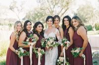 chic deep wine-colored maxi bridesmaid dresses with halter necklines and pleated skirts are gorgeous for the fall