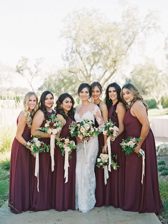 chic deep wine-colored maxi bridesmaid dresses with halter necklines and pleated skirts are gorgeous for the fall