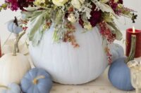 chic pastel table decor with pumpkins and a lush floral centerpiece with blooms and pale greenery