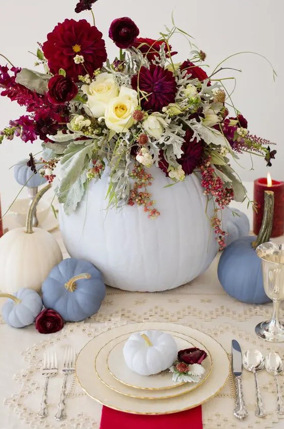 chic pastel table decor with pumpkins and a lush floral centerpiece with blooms and pale greenery