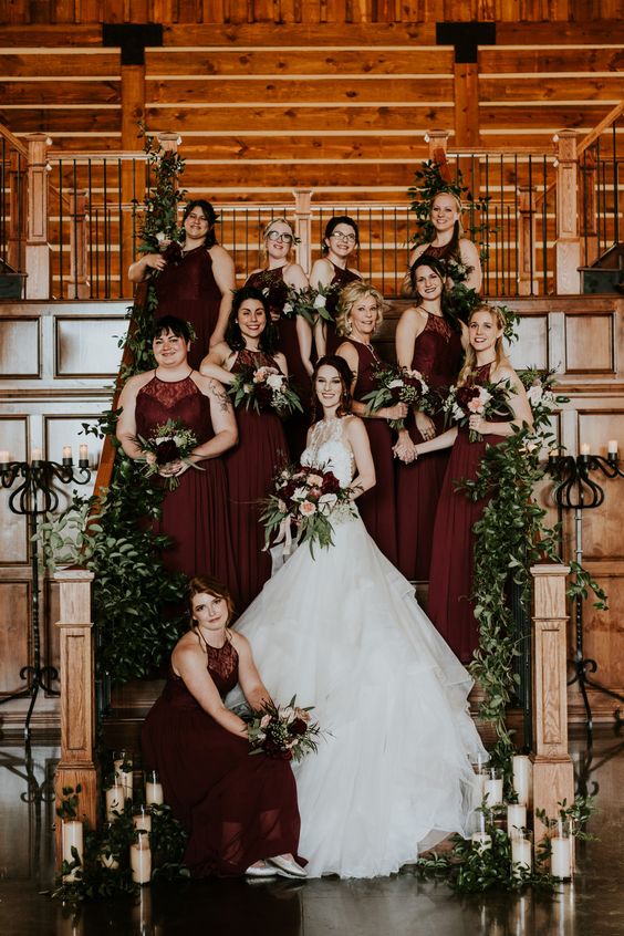 classic burgundy halter neck maxi bridesmaid dresses with lace bodices and pleated skirts for a refined fall wedding