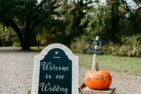 create simple and cool wedding decor using pumpkins with names and dates, a chalkboard marquee sign and a crate