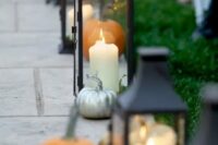 elegant fall wedding aisle decor with candle lanterns and silver and orange pumpkins will work for many wedding styles