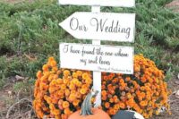 fall wedding decor with bright blooms, pumpkins, a candle lantern and a sign is a lovely solution