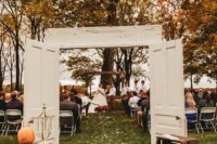 fall wedding decor with crates, pumpkins and bold blooms is a cool idea for an indoor or outdoor wedding