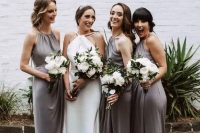grey midi bridesmaid dresses with halter necklines and draped bodices and silver shoes for a stylsh and elegant wedding