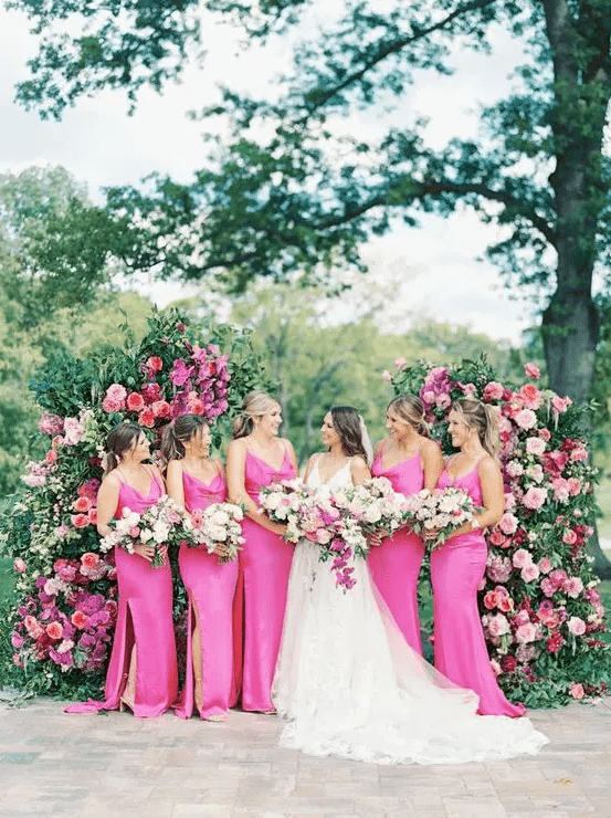 hot pink slip bridesmaid dresses with slits and trains are a great idea for a pink-infused summer or garden wedding