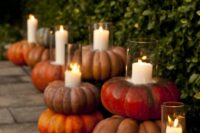 large heirloom pumpkins holding candles can be a nice wedding venue decoration, you can make them yourself